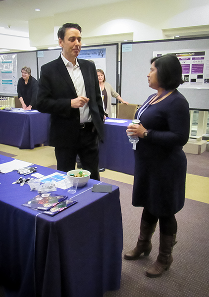 talking with visitors to the table 