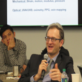 Dr. Ben Myers asks a question to panel members during a discussion